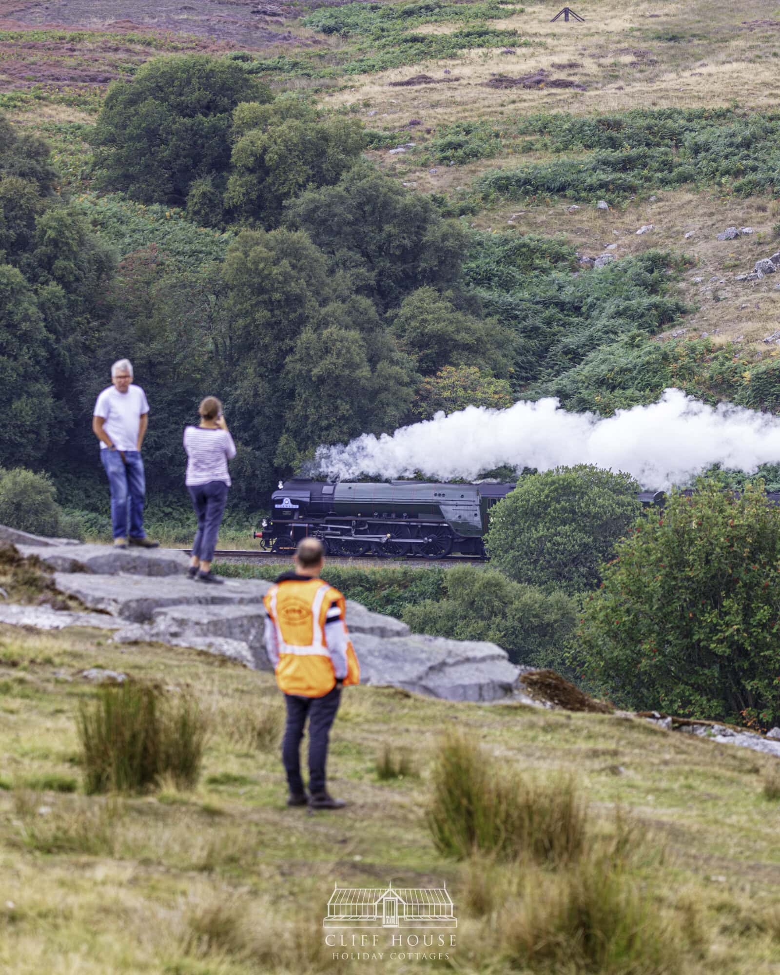 435a9347 cliff house holiday cottages steam train travelling through the north yorkshire moors railway surrounded by yorkshire countryside and historic station buildings steam train diaries